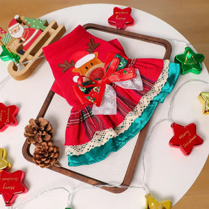 Red and green Christmas-themed outfit with decorative elements on a white surface.