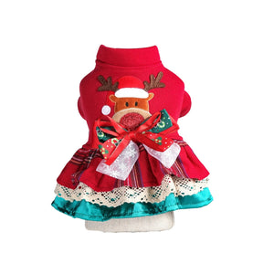 Red dog dress with reindeer design and bow on a white background