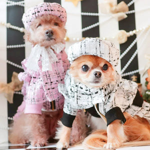 Dogs modelling the tweed beret cap in white and pink.