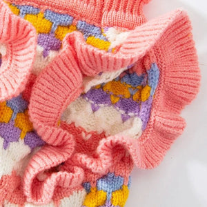 Elegant knitted flower dog sewater has frill sleeves.