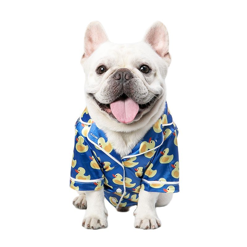 Made by designer Mooki, these blue PJs feature white piping and 3 buttons down the front. Modeled here on a French Bulldog.