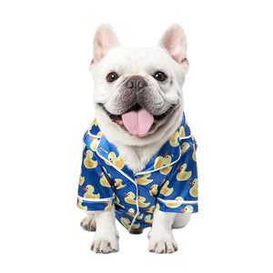 Made by designer Mooki, these blue PJs feature white piping and 3 buttons down the front. Modeled here on a French Bulldog.