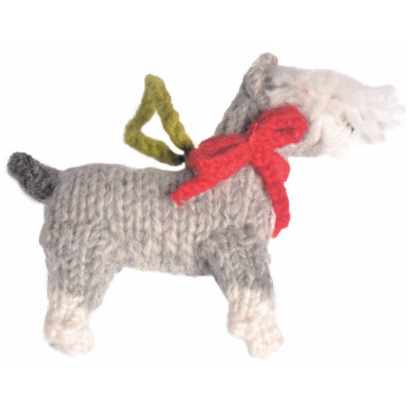 Knitted dog toy with a red bow on a white background