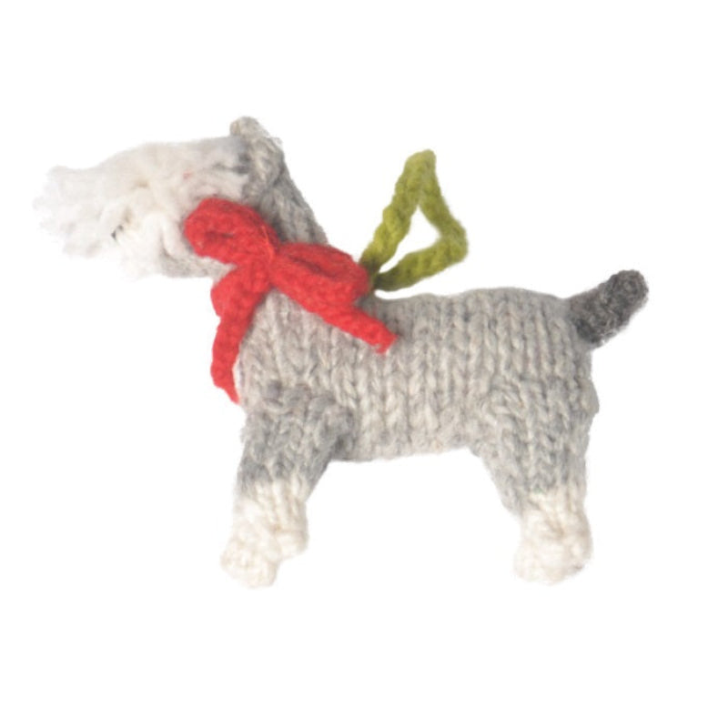 Knitted dog toy with a red bow on a white background