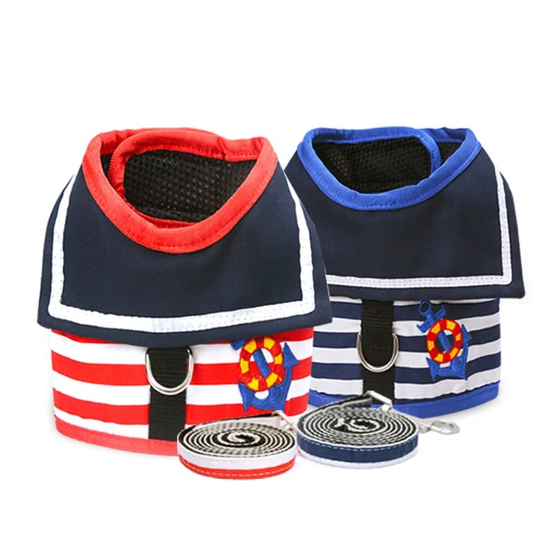 Two dog harnesses with red and blue accents, featuring anchor designs, on a white background.