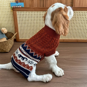 Cavalier King Charles Spaniel dog wearing burgundy tribal pattern dog sweater with elephants and suns at home