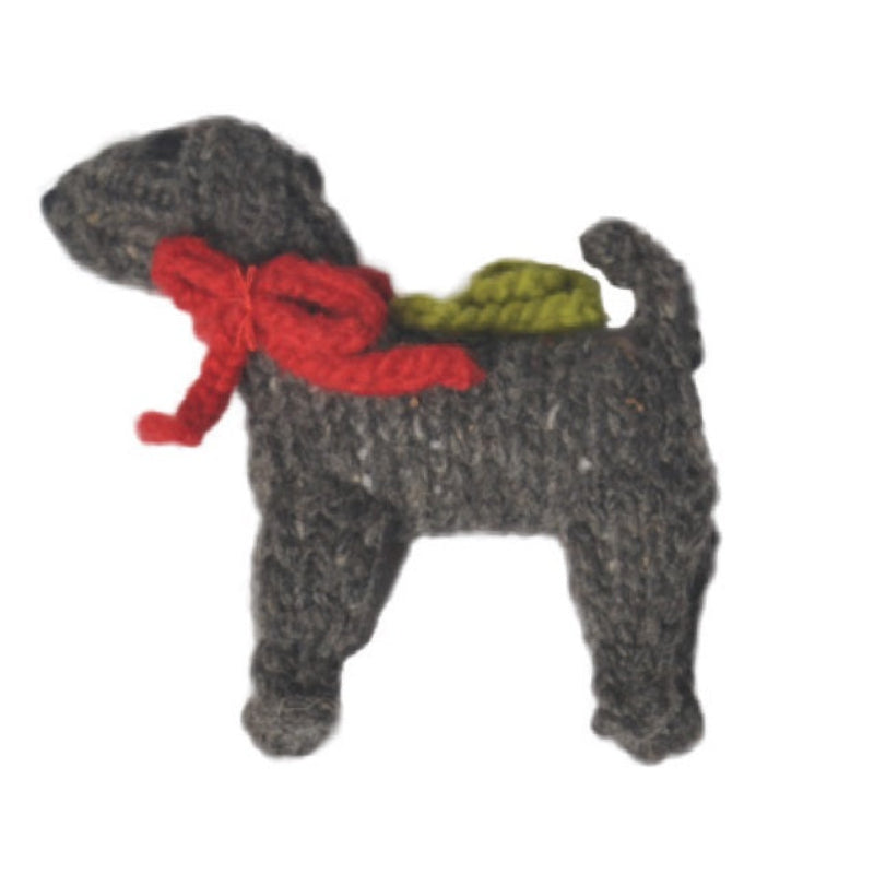 Knitted dog toy with a red bow on a white background