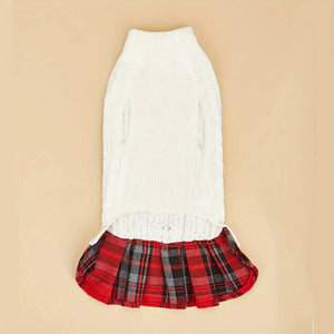White sweater with a red plaid skirt on a beige background
