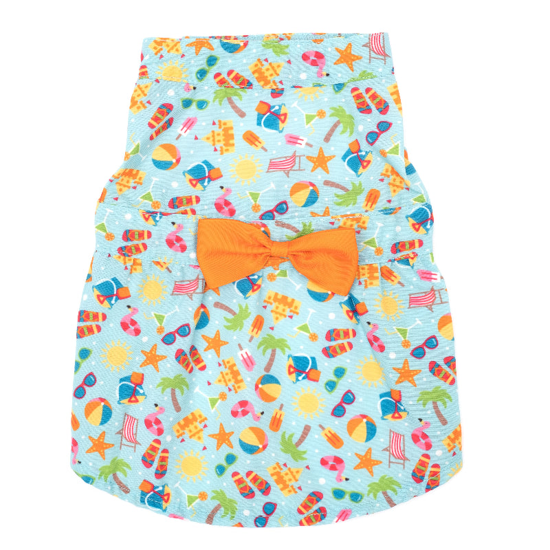 Dog dress with colorful beach pattern and orange bow on a white background