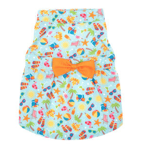 Dog dress with colorful beach pattern and orange bow on a white background