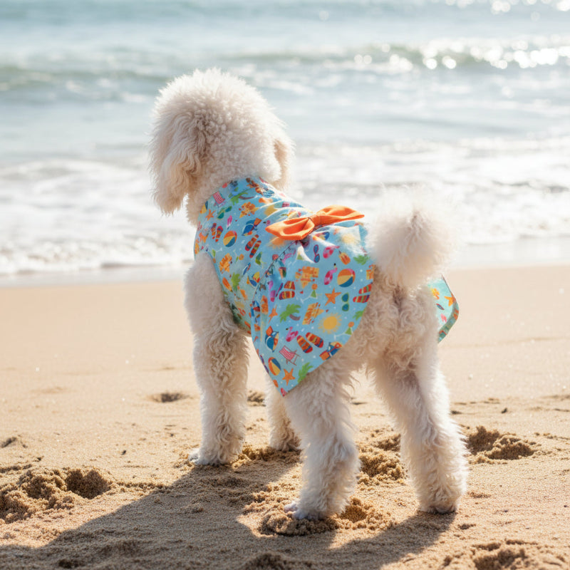 Dog dress with colorful beach pattern and orange bow on a white background