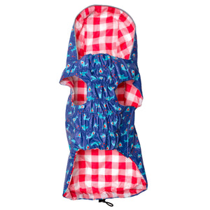 Navy dog raincoat with red and white checkered hood and blue body with shark pattern on a white background