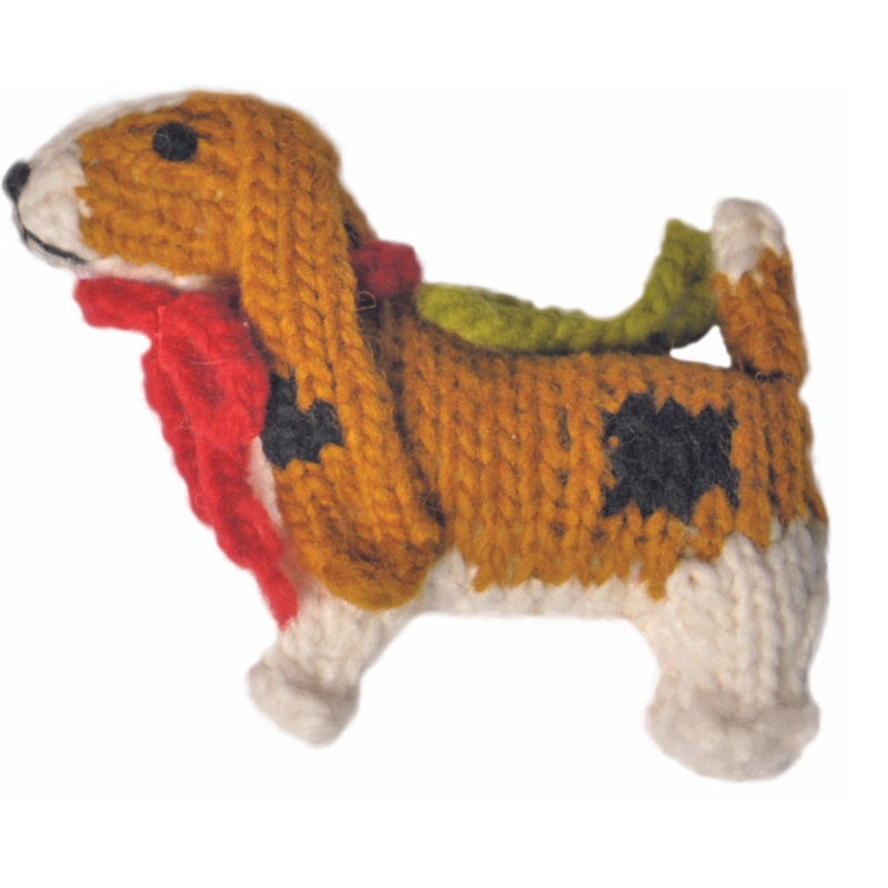 Basset hound knitted ornment with a red scarf on a white background