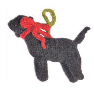 Knitted Black Lab dog ornament with a red bow on a white background