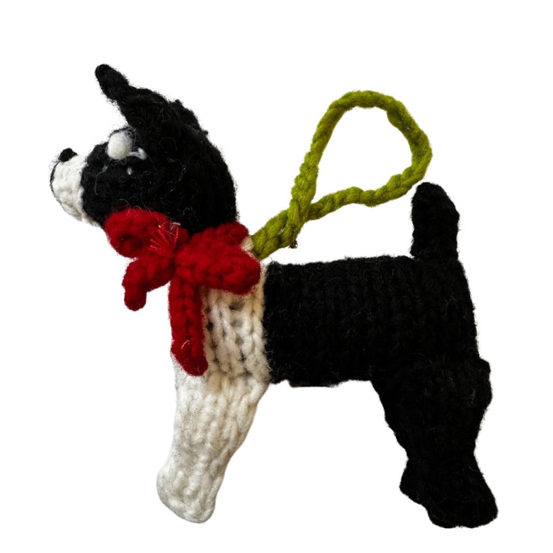 Knitted Boston Terrier ornament with a red bow tie on a white background