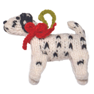 Knitted Dalmatian ornament with a red bow on a white background