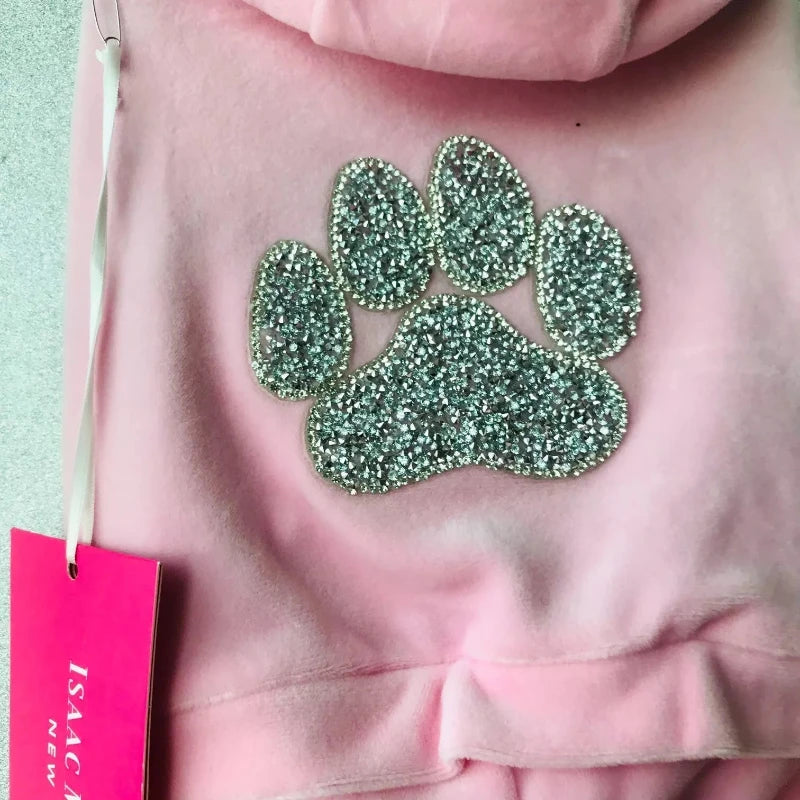 Isaac Mizrah light pink dog tracksuiti is hooded.
