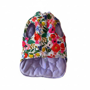 Floral-patterned dog puffer with a purple interior on white background