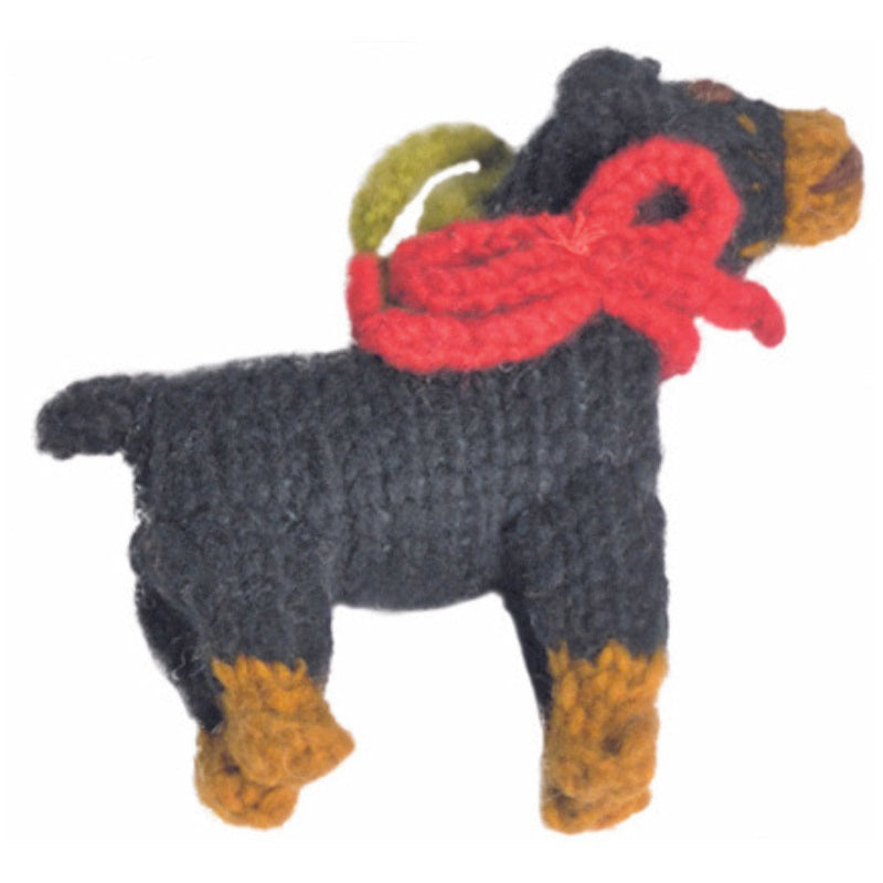 Knitted dog ornament with a red bow on a white background