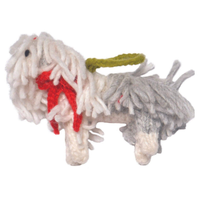 A handmade sheep dog ornament with shaggy white and gray yarn, a red felt bow, and an olive green leash, isolated on a white background.