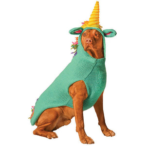 Dog wearing a green unicorn costume with a yellow horn on a white background