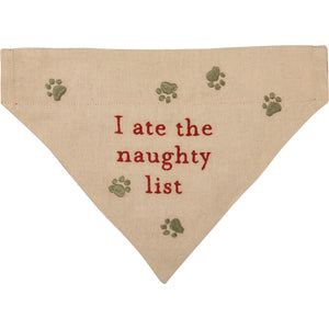 I Ate the Naughty List Reversible Christmas Dog Bandana in Cream with red lettering and green paw prints