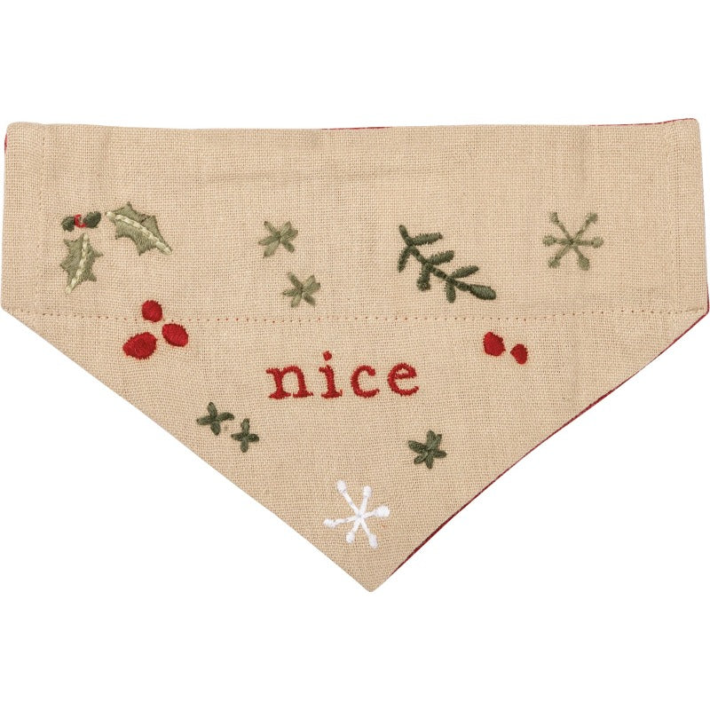 This red Christmas small reversible dog collar bandana features an embroidered "Naughty" sentiment and holiday botanical designs on one side.