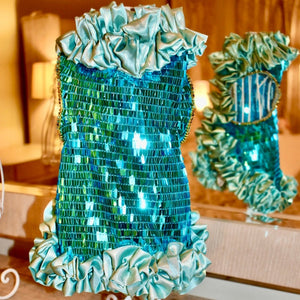 This handmade “Ariel” couture dog party dress is exquisitely crafted by C’Mimi’s world-renowned pet fashion Designer Jan Ben with glittering aqua rectangular sequins, a light blue satin ruffle neck, midline and skirt, and a gorgeous multicolored rhinestone trim on the sleeves.