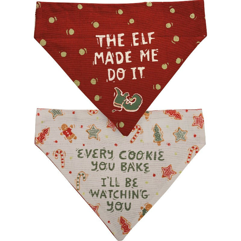 This reversible Christmas dog collar bandana features "Every Cookie You Bake I'll Be Watching You" sentiment and Christmas cookie designs on one side, and "The Elf Made Me Do It" sentiment with elf shoe and polka dot designs on the other.