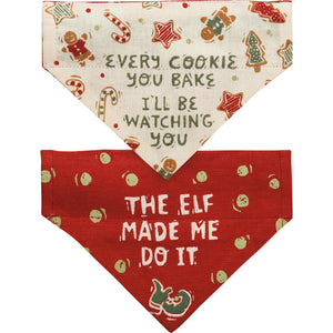 For small dogs, this reversible Christmas dog collar bandana features "Every Cookie You Bake I'll Be Watching You" sentiment and Christmas cookie designs on one side, and "The Elf Made Me Do It" sentiment with elf shoe and polka dot designs on the other.