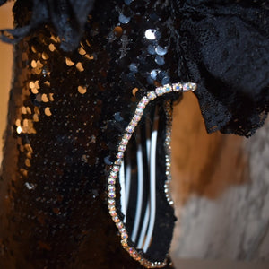 This handmade “Elektra” dress features bling rhinestone trim around the sleeves.