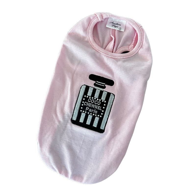 Made of 100% Pima cotton, this designer-inspired embroidered dog T-shirt by Aventura Pups features a Chewnel black-and-silver perfume bottle on a light pink T-shirt