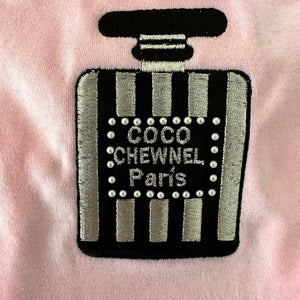 This designer-inspired embroidered dog T-shirt by Aventura Pups features a Chewnel black-and-silver perfume bottle on a light pink T-shirt