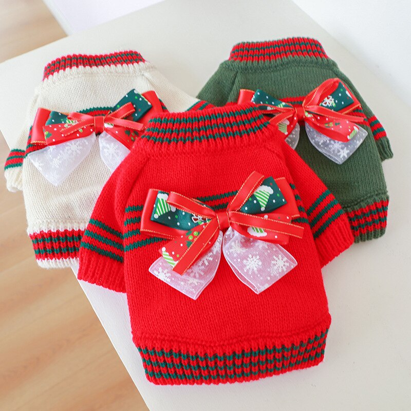 Absolutely adorable, this festive Christmas Bow Turtleneck Dog Sweater is available in three colors: White, Red or Green for small to medium dogs. Here pictured in white body. Neck and sleeves in red/green stripes. Red and white Christmas bow on center of back.