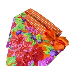 Handmade in the USA by Chloe & Max, this Orange & Pink Flowers Bandana Dog Collar features bright orange, pink, red, purple and green flowers on orange with orange polka dot trim and backing.