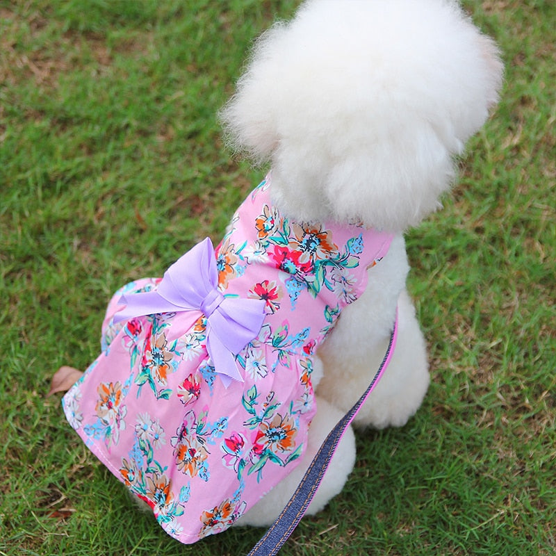 Adorned with a purple bow, this lightweight cotton Pink Floral Dog Dress from our Spring/Summer collection is great for weddings and parties.