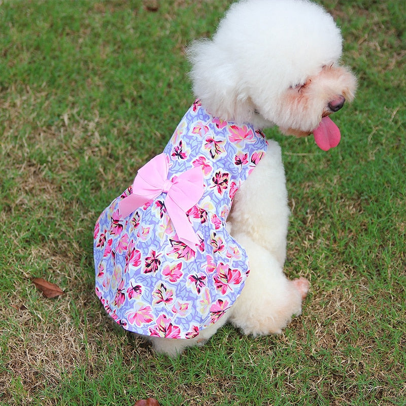 This lilac floral dog dress features a light pink bow.