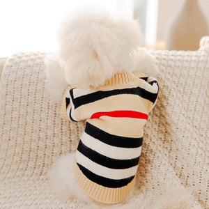 This classy Striped Button-Down Dog Cardigan is cream, with black, cream, white and red horizontal stripes.