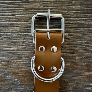 Tan Leather strap has a metal buckle