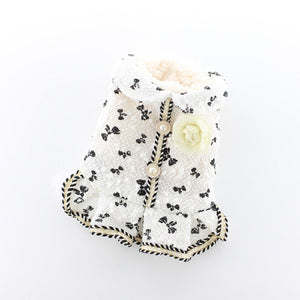 Available in white, this elegant dog dress is adorned with a bow pattern, faux pearl buttons and rose flower brooche.