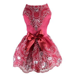 Sleeveless design features a large satin bow and tulle underskirt.