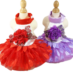Your pup will make an eyecatching statement wearing this festive Floral Tulle Tutu Dog Party Dress, available in red or purple.