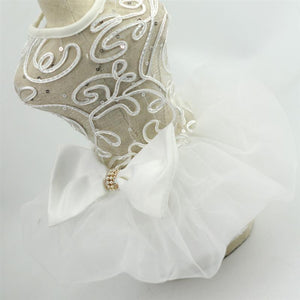A large bow with faux pearls adorns the waist of this Luxurious White Lace Dog Wedding Dress.