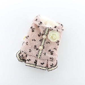 Available in pink, this elegant dog dress is adorned with a bow pattern, faux pearl buttons and rose flower brooche. 