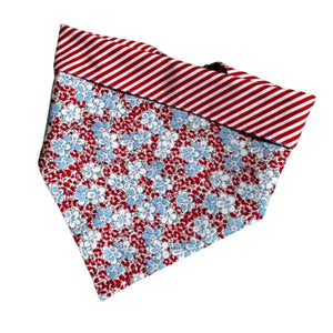 Handmade in the USA by Chloe & Max, this Red & Light Blue Flowers Bandana features red, white and blue flowers, with red-and-white striped trim and backing. 