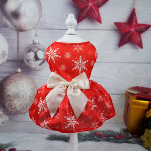 Perfect for holiday parties, this red Christmas Snowflake Dog Party Dress features white snowflakes and a white satin bow for small to medium dogs.